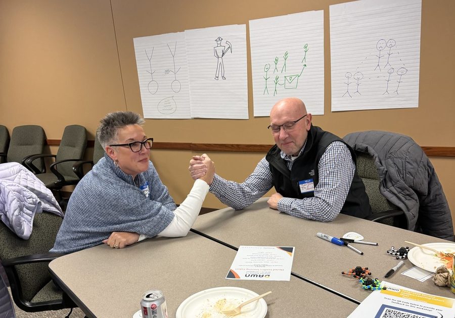 Two participants practicing negotiation across a table